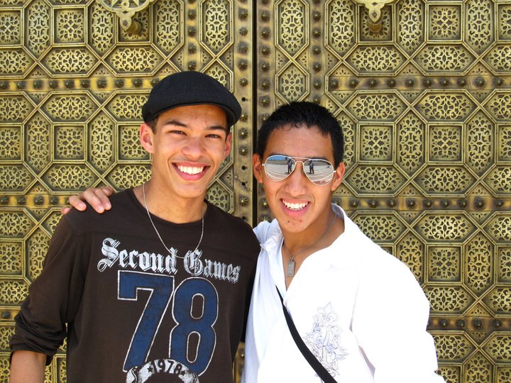 Carlo posing with a friend in Morocco in front of a decorative door