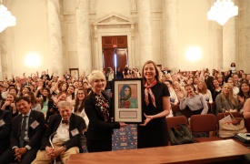 Lea Bagi (left), from Serbia, presented Assistant Secretary Marie Royce (right), of the Bureau of Educational and Cultural Affairs, with a print of her painting, "The Beauty of Diversity." 