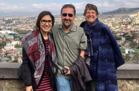 Brian and Sheila Green, with Georgian Fellow, Veka, posing together with views of Tblisi in the background