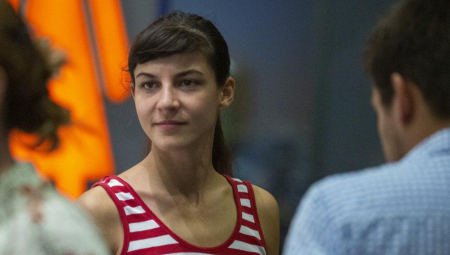Tamara Kotevska, looks to the left of the camera, wearing a red and white striped top