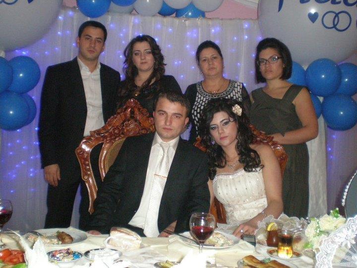 Megan with her host family at a wedding, posing with the bride and groom