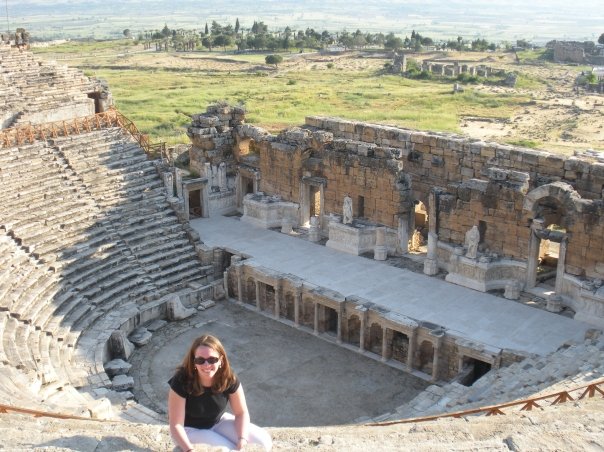 Emily poses in an amphitheater in Turkey, where she did research before graduate school