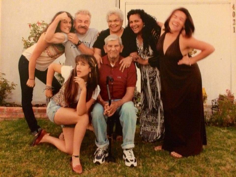 Megan and her family, posing in the yard, crowded around her grandparents