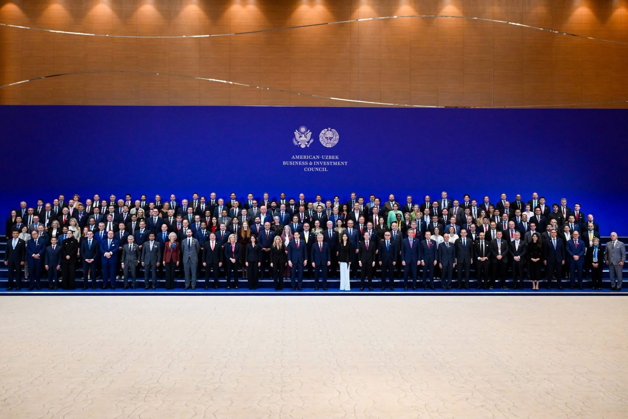 Group photo in front of screen that says "American-Uzbek Business & Investment Council"