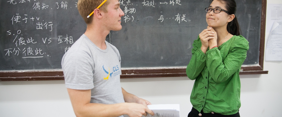 Two CLS Shanghai students in front of a chalkboard in class