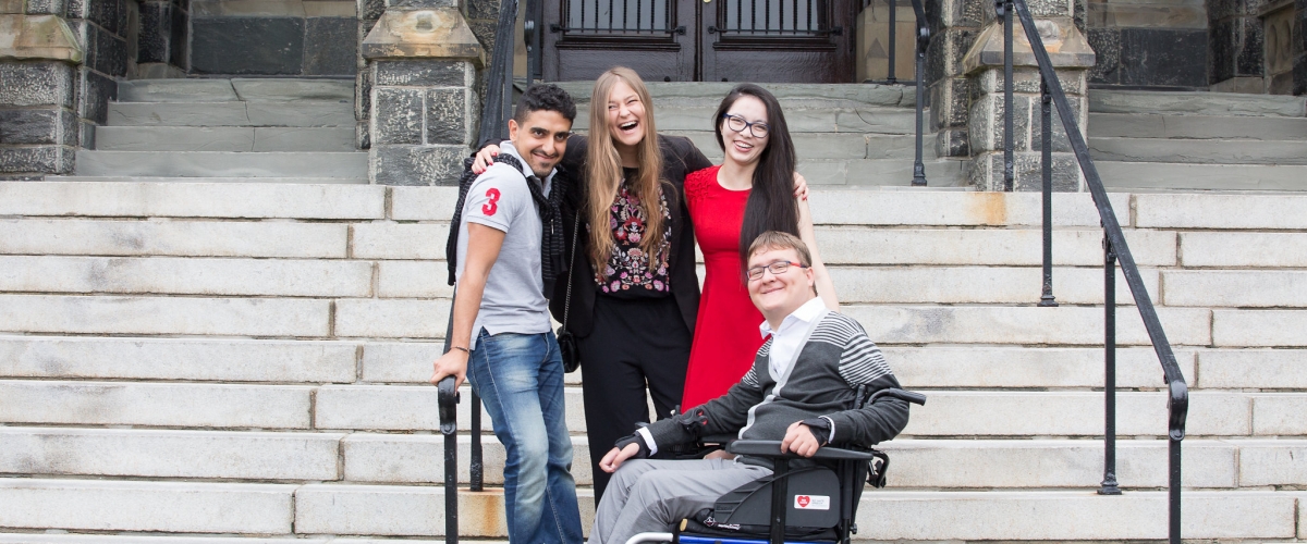 Students pose for a photo on steps