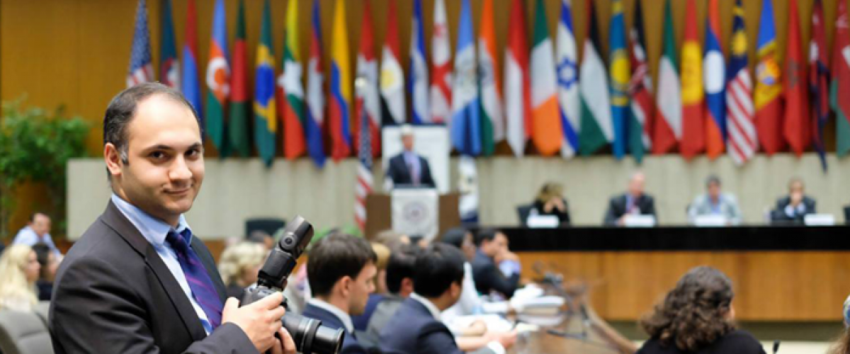 A young professional from Armenia smiles for the camera from a government office