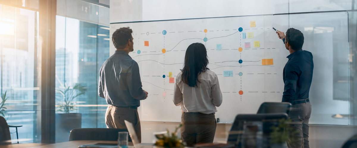 Three people at whiteboard
