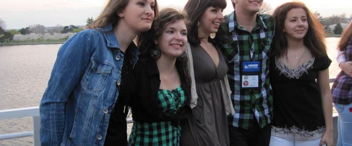 Image of 5 alumni smiling for a photo