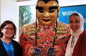 Two people pose with Taiwan art at the silent auction event. 