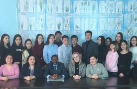 Group of US and Kazakh higher education staff seated together on a site visit in Kazakhstan