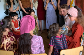 A young woman reads to children at the newly completed library. 