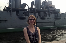 Samantha Williams, posing in front of a ship in Russia