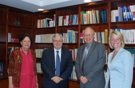 CIC and American Councils leadership gather in front of a bookcase