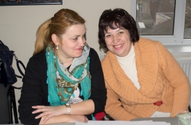 Two women smile for the camera.