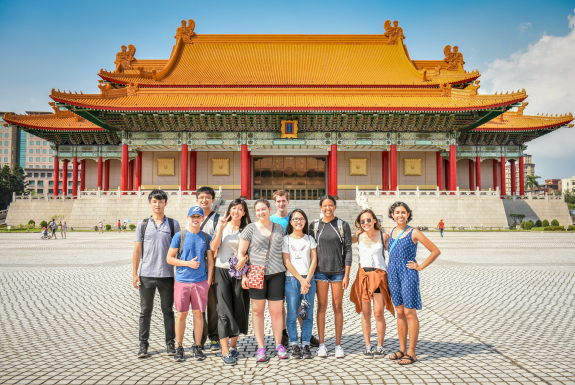 Taiwan study abroad group smiling in front of memorial building