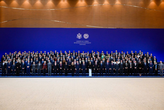 Group photo in front of screen that says "American-Uzbek Business & Investment Council"