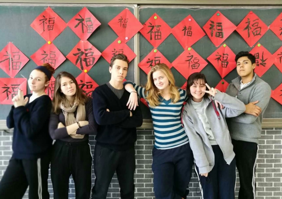 Chinese language students pose for the camera in front of the classroom