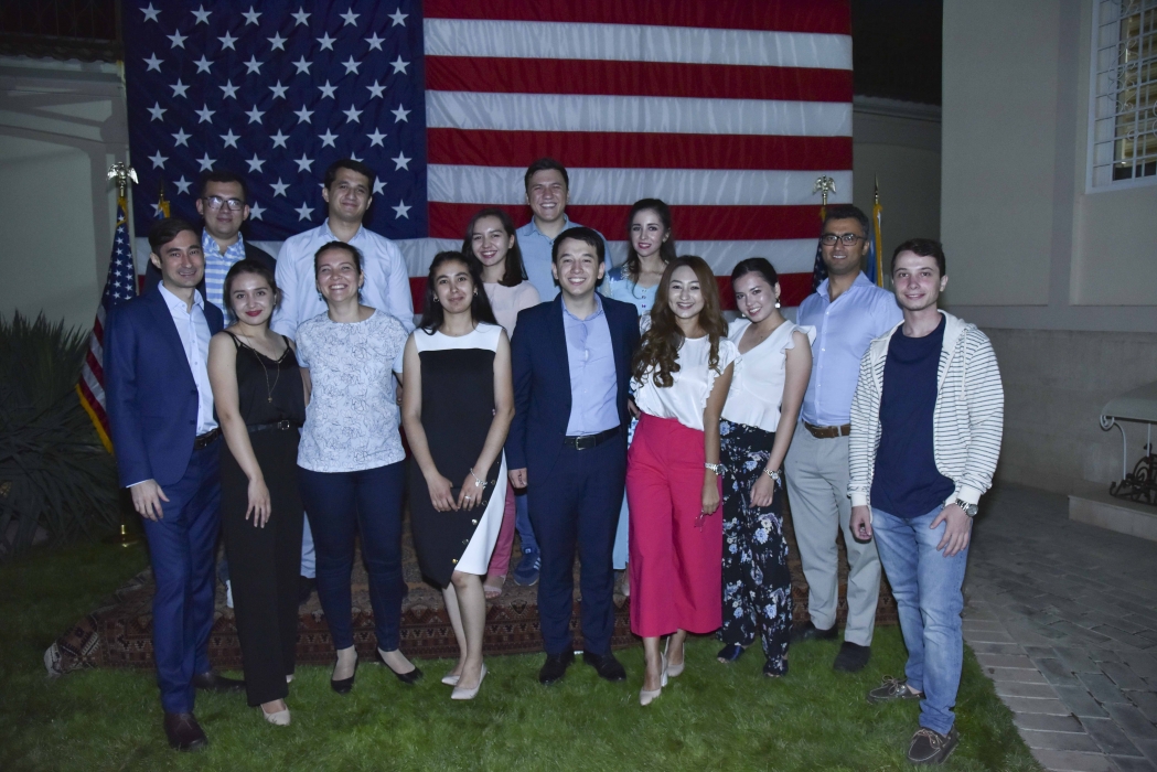 The inaugural group of UBL fellows, posing in front of the American flag