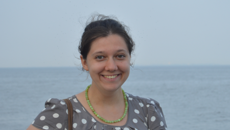 Tanya, headshot, with a seaside background