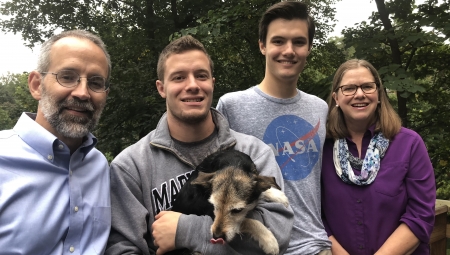 The Spawn family, including son Kyle and mother Carla (right), are all smiles with the rest of their family pose for a photo (including their cute puppy!)