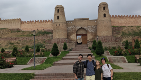 Students on the summer Eurasian program posing in front of a castle