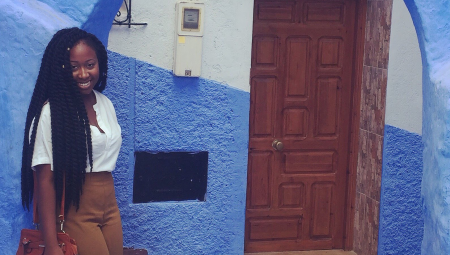 Ermida, during her CLS exchange, standing in a bright blue doorway