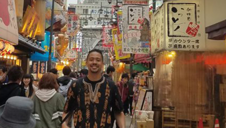 Elias, posing on a street in Japan, during his 2014 study abroad experience