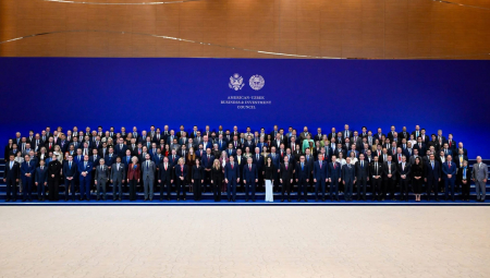Group photo in front of screen that says "American-Uzbek Business & Investment Council"