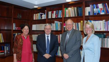 CIC and American Councils leadership gather in front of a bookcase