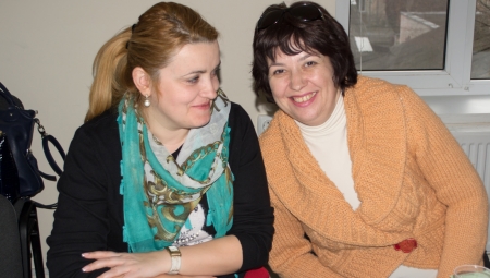 Two women smile for the camera.